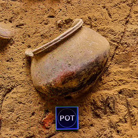 This embedded pot discovered in situ was likely used for grain storage within a residential unit. Such features demonstrate how architecture integrated everyday utility and storage