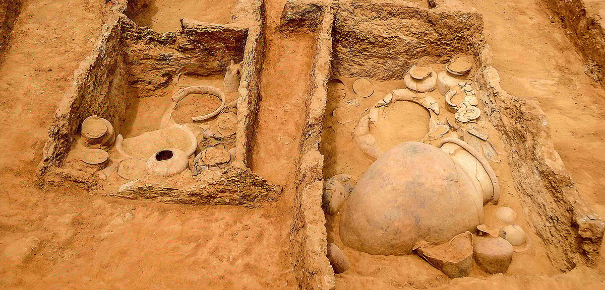 This aerial view of a trench reveals a complex twin-chambered structure containing large burial urns and pottery. Such features indicate a sophisticated funerary practice, with evidence pointing to secondary burials and ritualistic offerings
