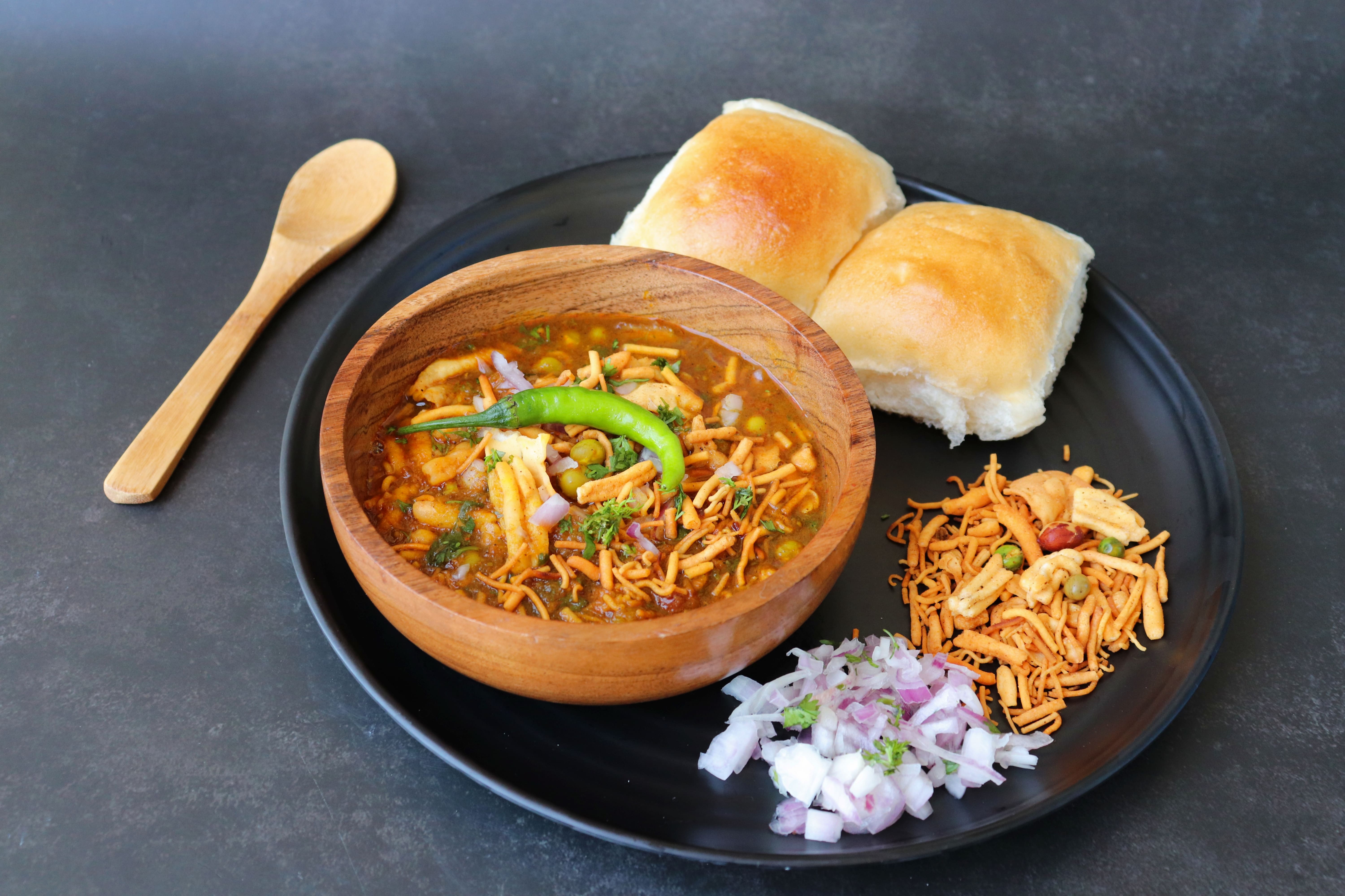 Misal pav consists of a vegetable curry (mostly made from moth beans) an Indian bread roll