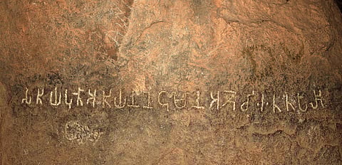 A clear Tamil Brahmi inscription etched on a rock. Such inscriptions are key in understanding the early literacy and linguistic evolution in South India