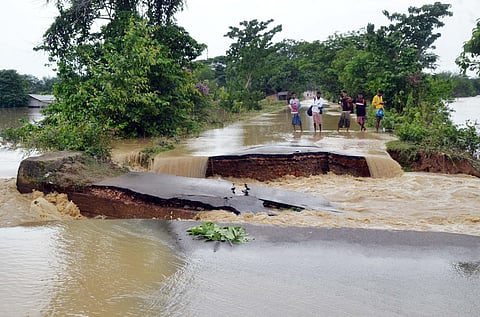 Floods wash away a road in Assam in 2022. Excessive rainfall is one of the consequences of a warming planet