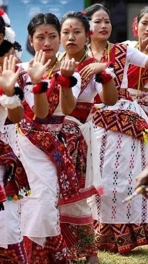 Women and girls from the 'Mising' tribe in Assam perform a dance