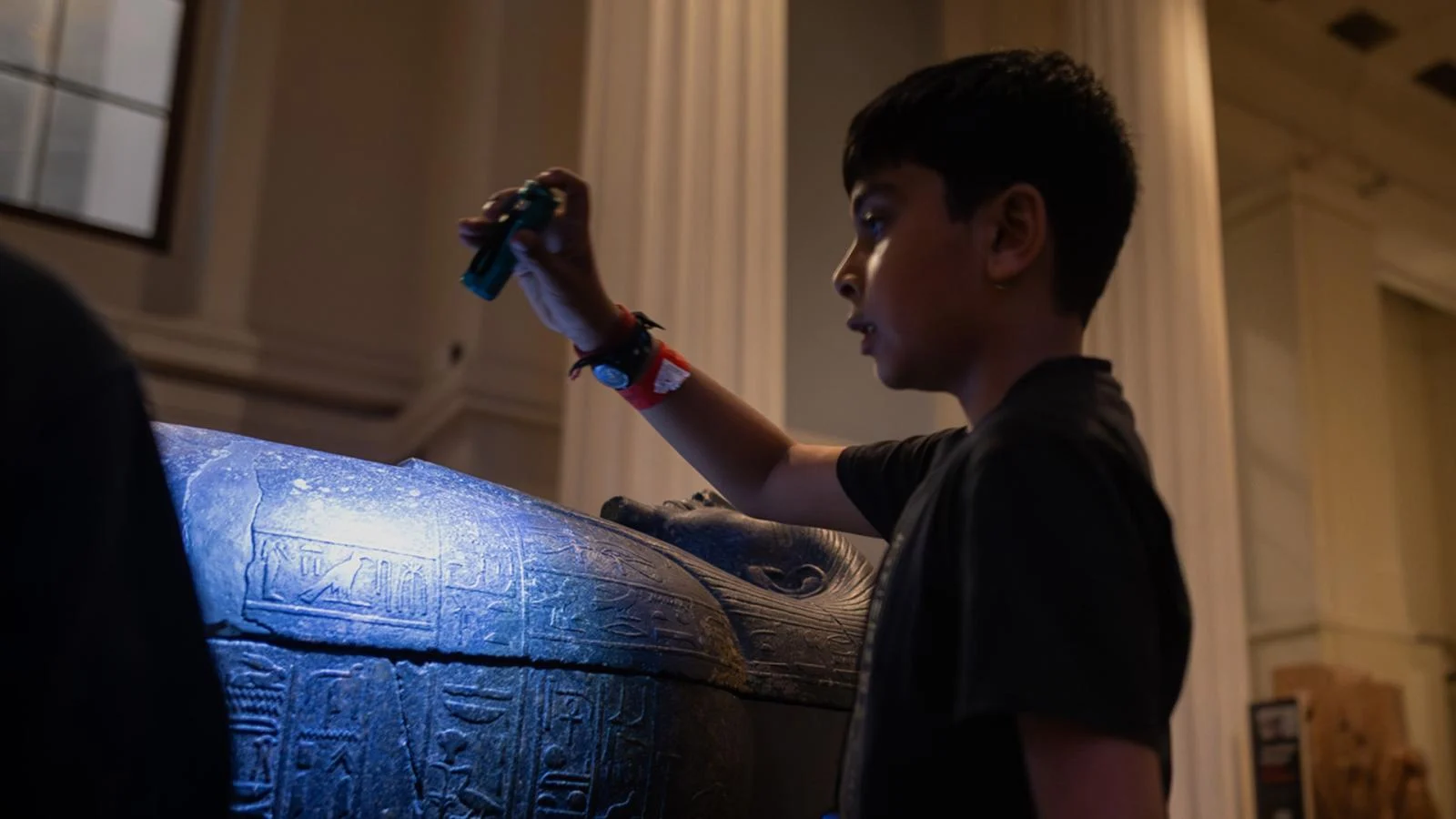 A child inspects a sculpture in the Egyptian gallery of the British Museum