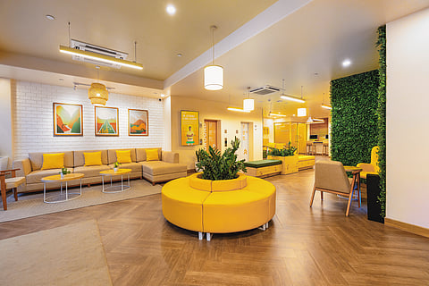 The hotel features vibrant decor and functional workspaces