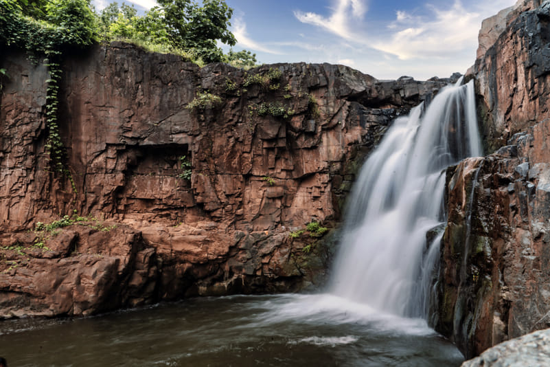 Zarwani Waterfall Cascading down the Rocks Image.