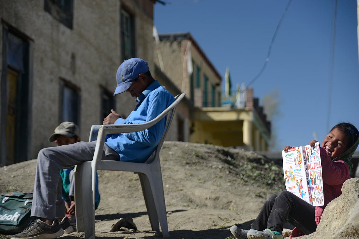 Children wait for the schoolbus in Langza