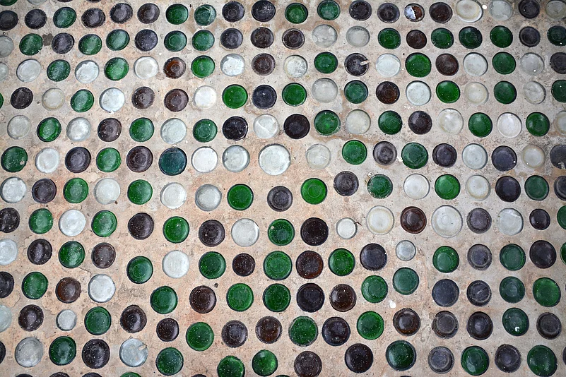 Beer bottles have been embedded in the walls and pillars of Wat Pa Maha Chedi Kaew