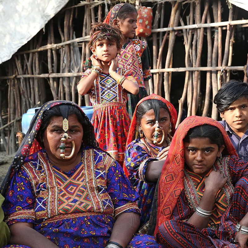 Dhaneta Jat women wear crescent-shaped gold nose rings called nathlis, which are held upright by strands of thread pinned to their hair