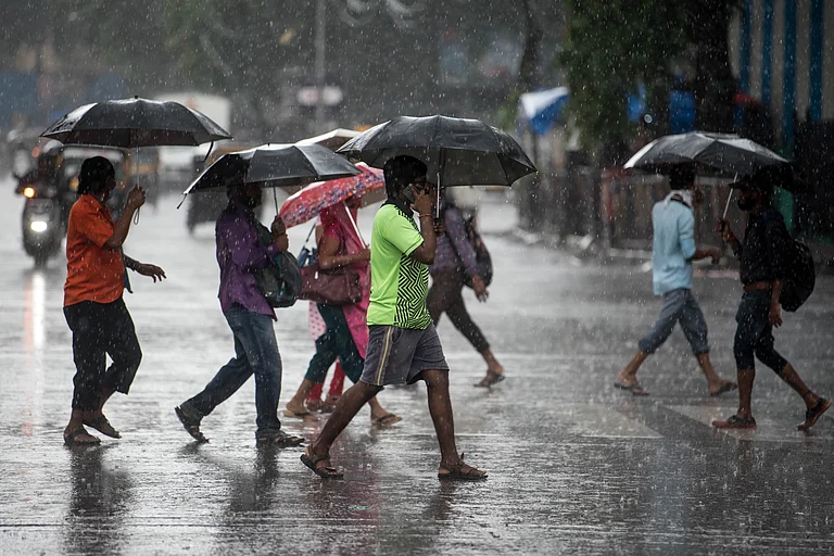 People cross a road as heavy rainfall lashes the city (representational image) - Manoej Paateel/Shutterstock
