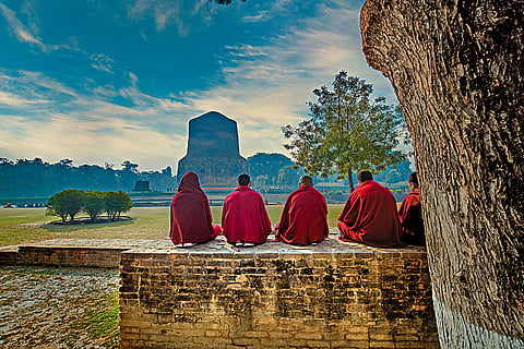 Buddhist monks in prayer near the Sarnath Stupa in Varanasi, Uttar Pradesh
