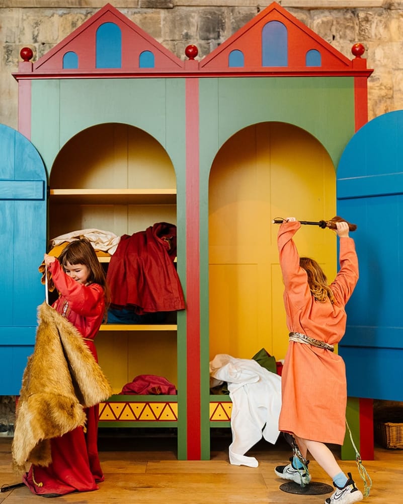 Children dress up in Norman clothes for a photo opportunity