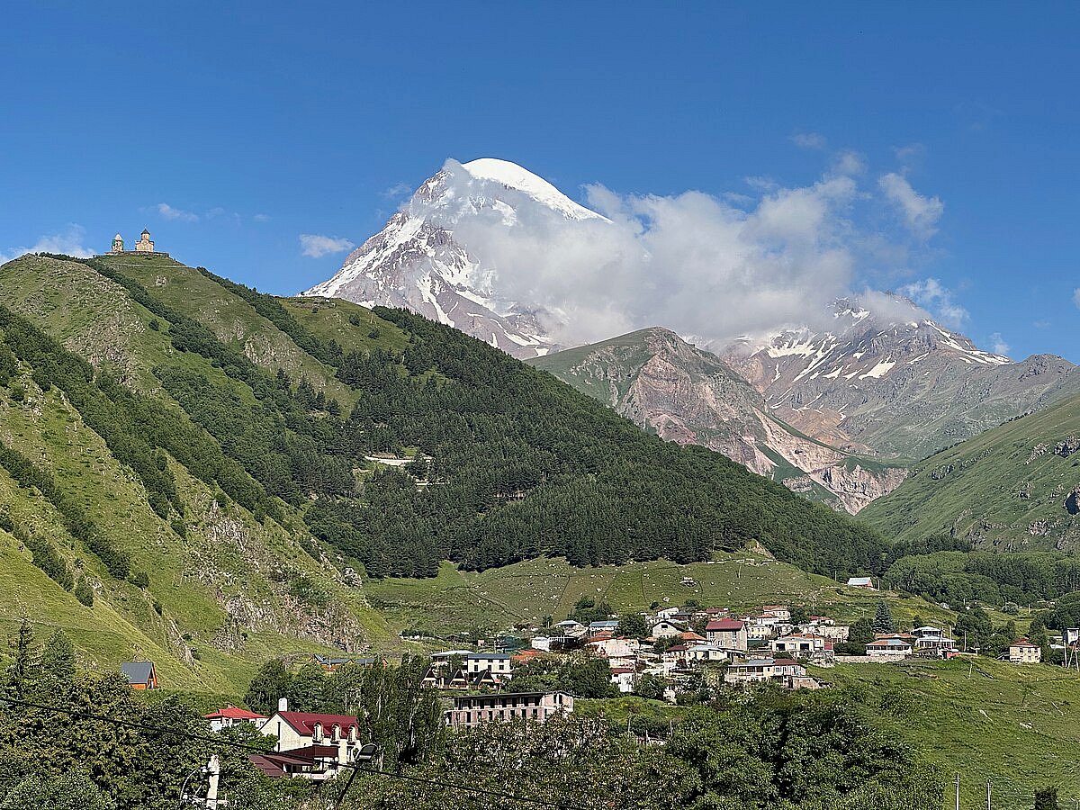 Dominated by the majestic Mount Kazbek and the iconic Gergeti Trinity Church perched high above, the town blends natural grandeur with spiritual heritage.