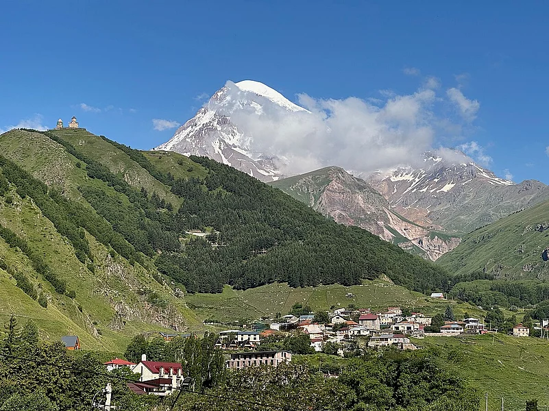 Dominated by the majestic Mount Kazbek and the iconic Gergeti Trinity Church perched high above, the town blends natural grandeur with spiritual heritage.
