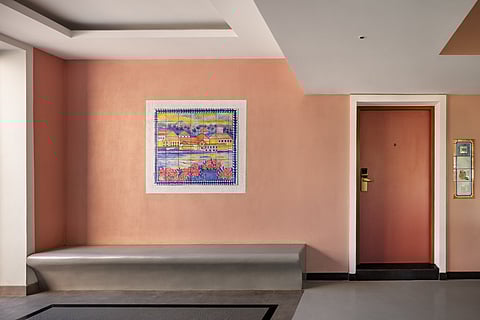 A corridor with a bespoke number plate and art as crafted by Studio IV Designs