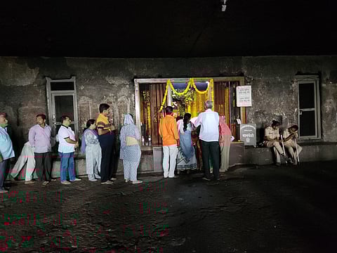 Worshippers pray to the Ganesha idol at the Girijatmaj Temple