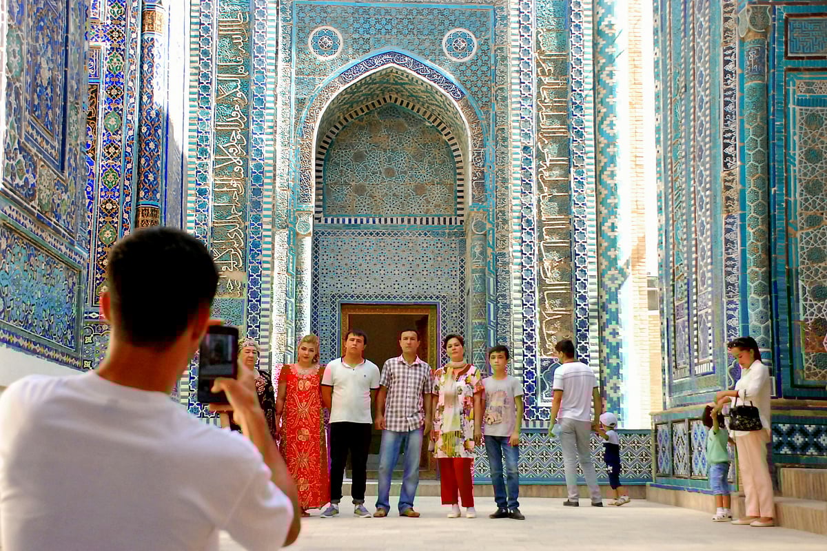 Tourists framed against the mosaics of Shah-i-Zinda.