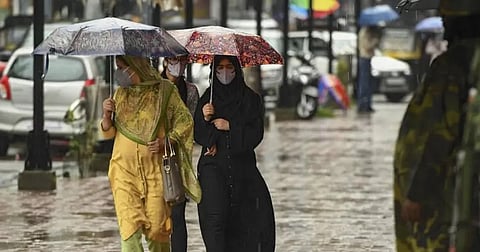 Residents and travellers navigate through the torrential showers across Jammu and parts of South Kashmir. 
