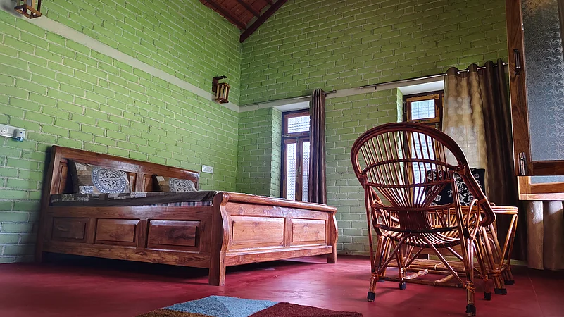 A cozy homestay room in Ladpura Khas, blending rustic charm with comfort and cultural décor