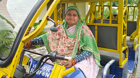 Nirmala Kushwaha, a single mother and e-rickshaw driver in Ladpura Khas, empowers herself and supports her family while offering safe transport for visitors