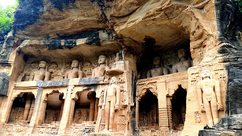 Intricately carved Jain Tirthankara figures grace the rock-cut temples beneath Gwalior Fort’s cliffs