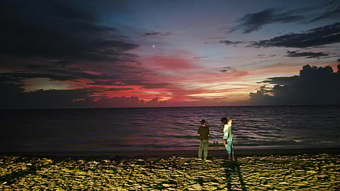 Visitors at a beach in Marari, Kerala