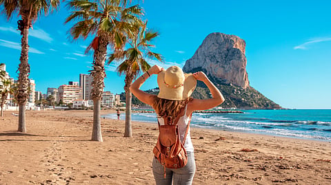 Woman tourist on the tropical beach, Calpe, Alicante province in Spain, Costa Blanca