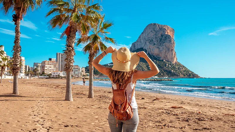 Woman tourist on the tropical beach, Calpe, Alicante province in Spain, Costa Blanca