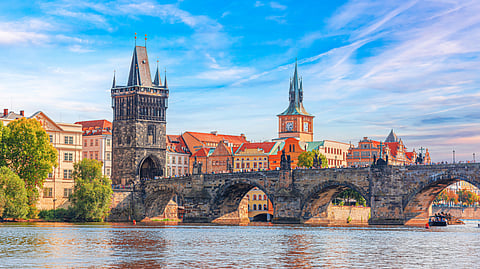 Scenic aerial sunset on the architecture of the Old Town Pier and Charles Bridge over the Vltava River | Prague, Czech Republic