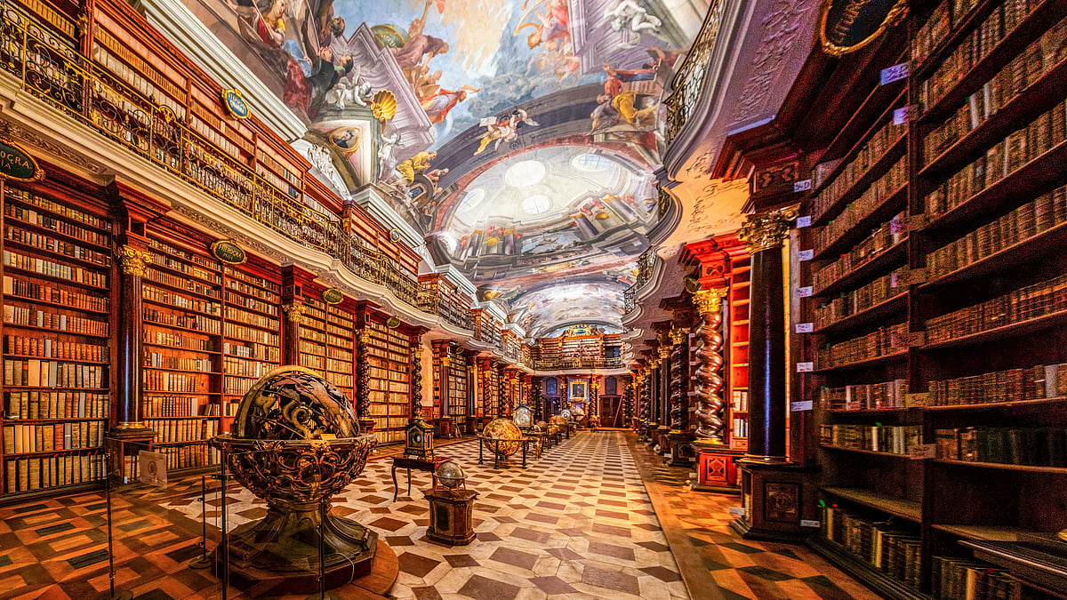 Interior of ancient baroque library inside the Astronomical tower of Klementinum complex with collections of unique books, globes, antique clocks | Prague, Czech Republic