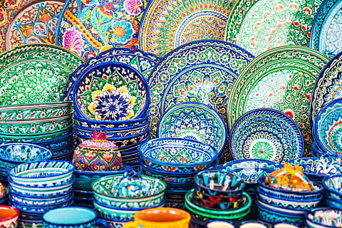 Multicoloured ceramic dishes with oriental ornaments at the Siab Bazaar in the ancient city. Samarkand, Uzbekistan