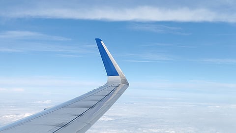 Aerial view of clouds and sky from airplane window during air travel