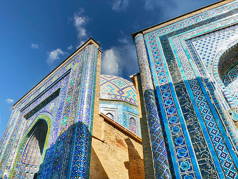 Ornate blue mosaic tiles adorning historic Shah-i-Zinda necropolis walls in Samarkand, Uzbekistan