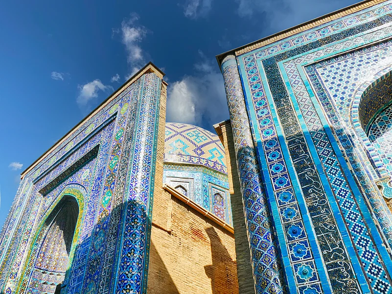 Ornate blue mosaic tiles adorning historic Shah-i-Zinda necropolis walls in Samarkand, Uzbekistan
