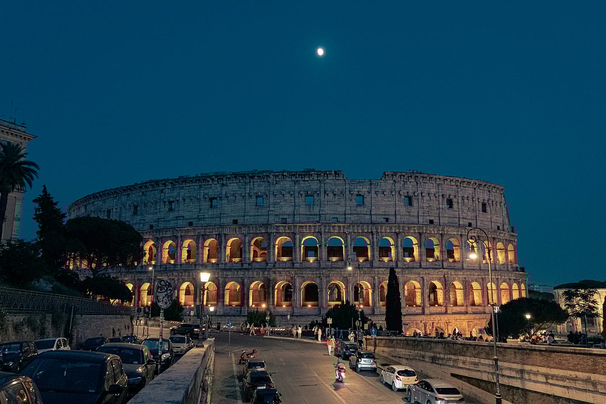 Unsplash : The Colosseum glows against the night sky, inviting travellers into its historic underground.