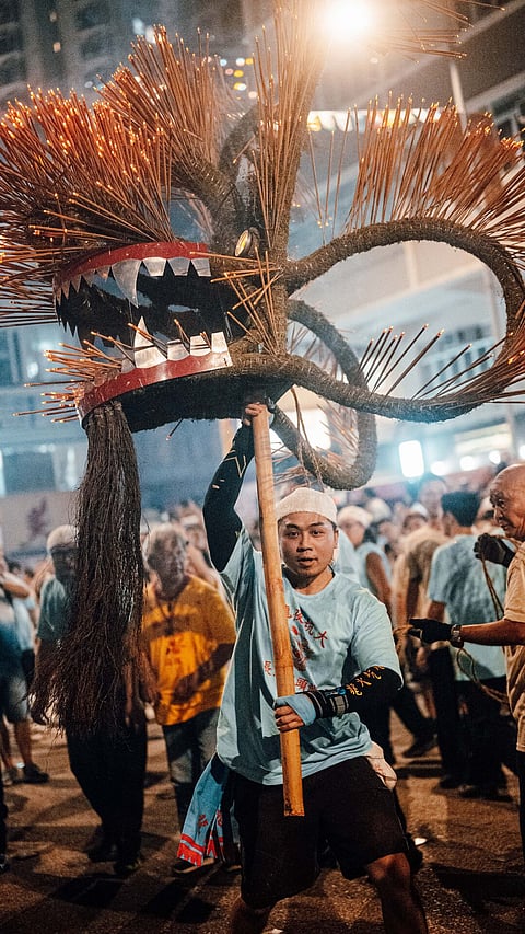 Man with an incense-studded dragon