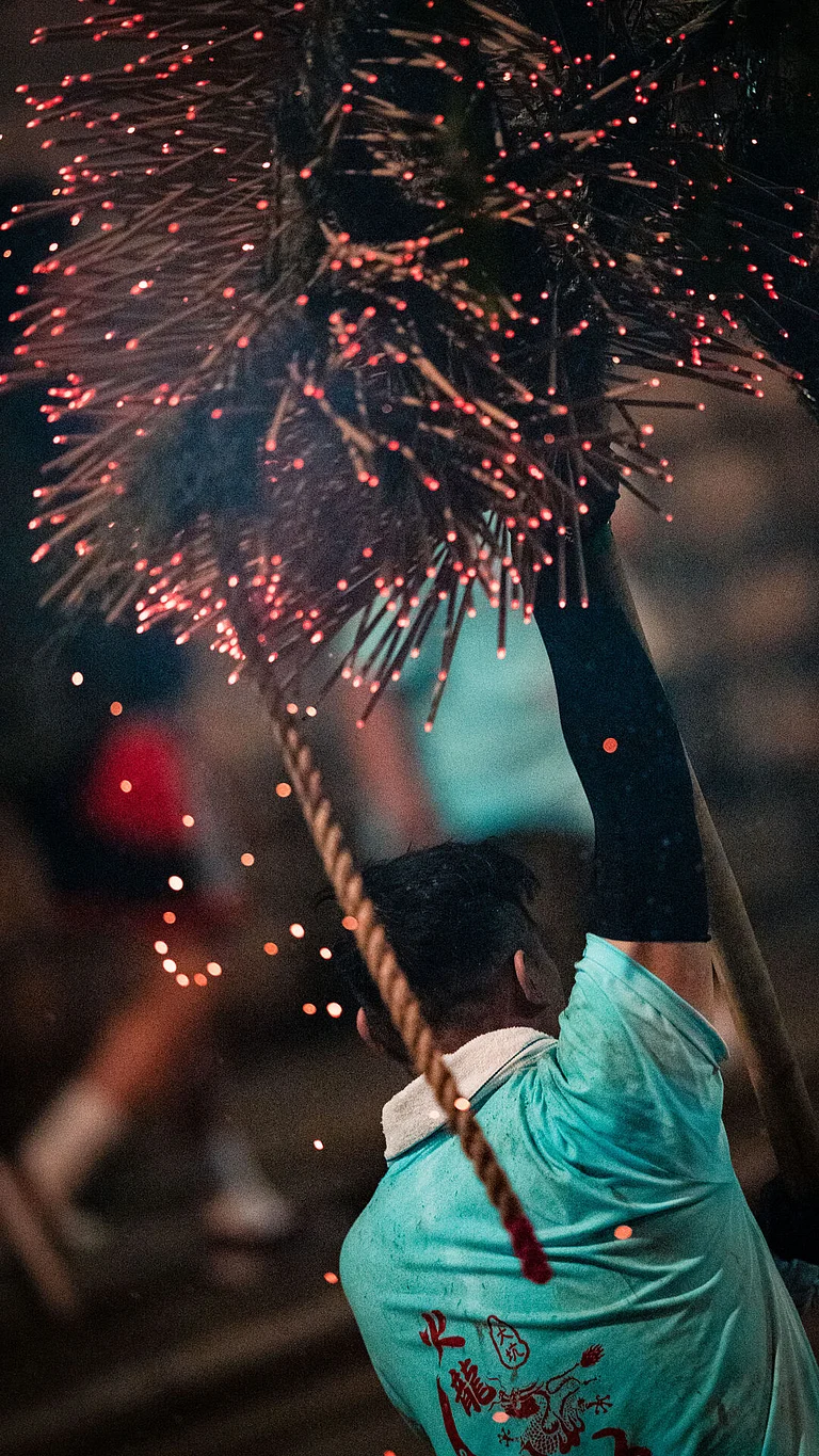 A man at the Tai Hang Fire Dragon Dance - Hong Kong Tourism Board (HKTB)