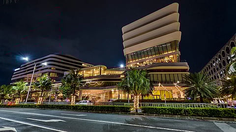 Conrad Manila’s striking modern facade illuminated by the city’s vibrant lights 