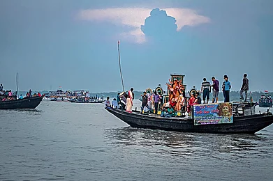 Photo: Debmalya Das : The immersion of Durga idols in the Ichamati River draws hundreds of people