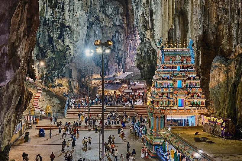 Interior view of Batu Caves’ Sri Velayuthar Temple in Gombak, Malaysia, with visitors exploring