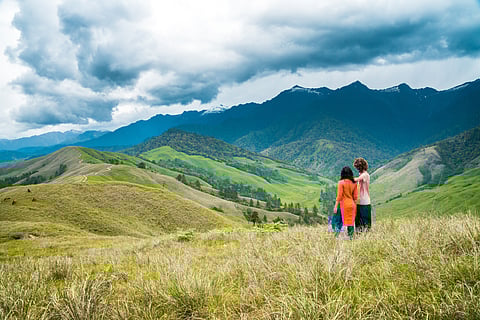 A couple takes in the misty mountain views of Mechuka, Arunachal Pradesh