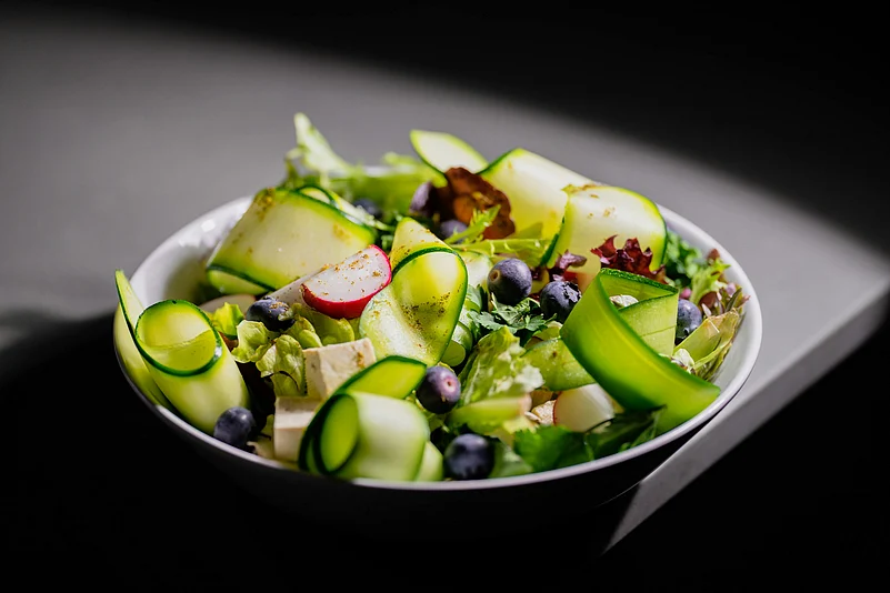 Start every meal with a salad, says Kaka. It steadies your energy and keeps those travel sugar spikes in check.