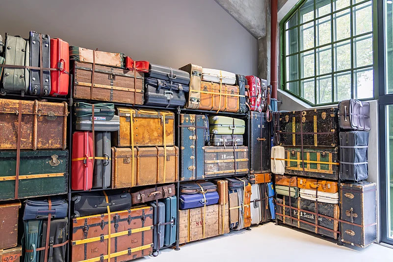 Stacked vintage suitcases at the Fenix Museum of Migration, symbolising stories of migration