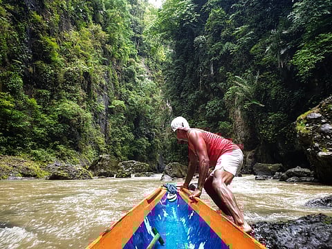 A canoe navigates the lush Pagsanjan Gorge, leading visitors to the iconic Pagsanjan Falls