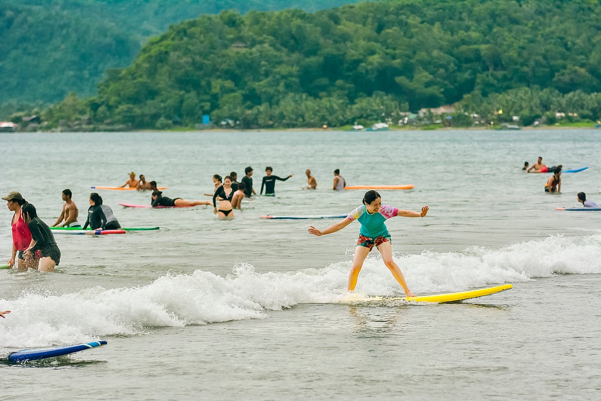 Shutterstock : A tourist rides gentle waves at Sabang Beach