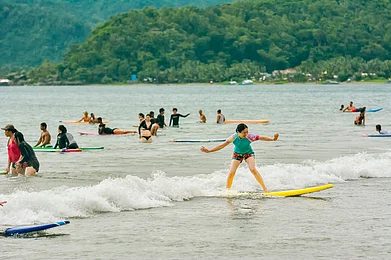 Shutterstock : A tourist rides gentle waves at Sabang Beach