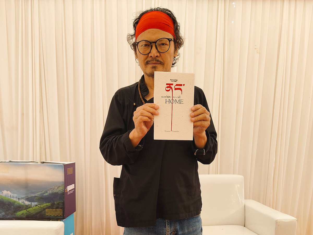 Tenzin Tsundue with his book Nowhere To Call Home at Yaanam 2025, Varkala, Kerala