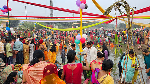 Devotees gather by the riverbank to celebrate Chhath Puja