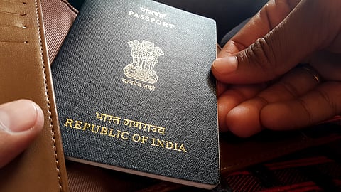 An Indian passport being taken out of a wallet