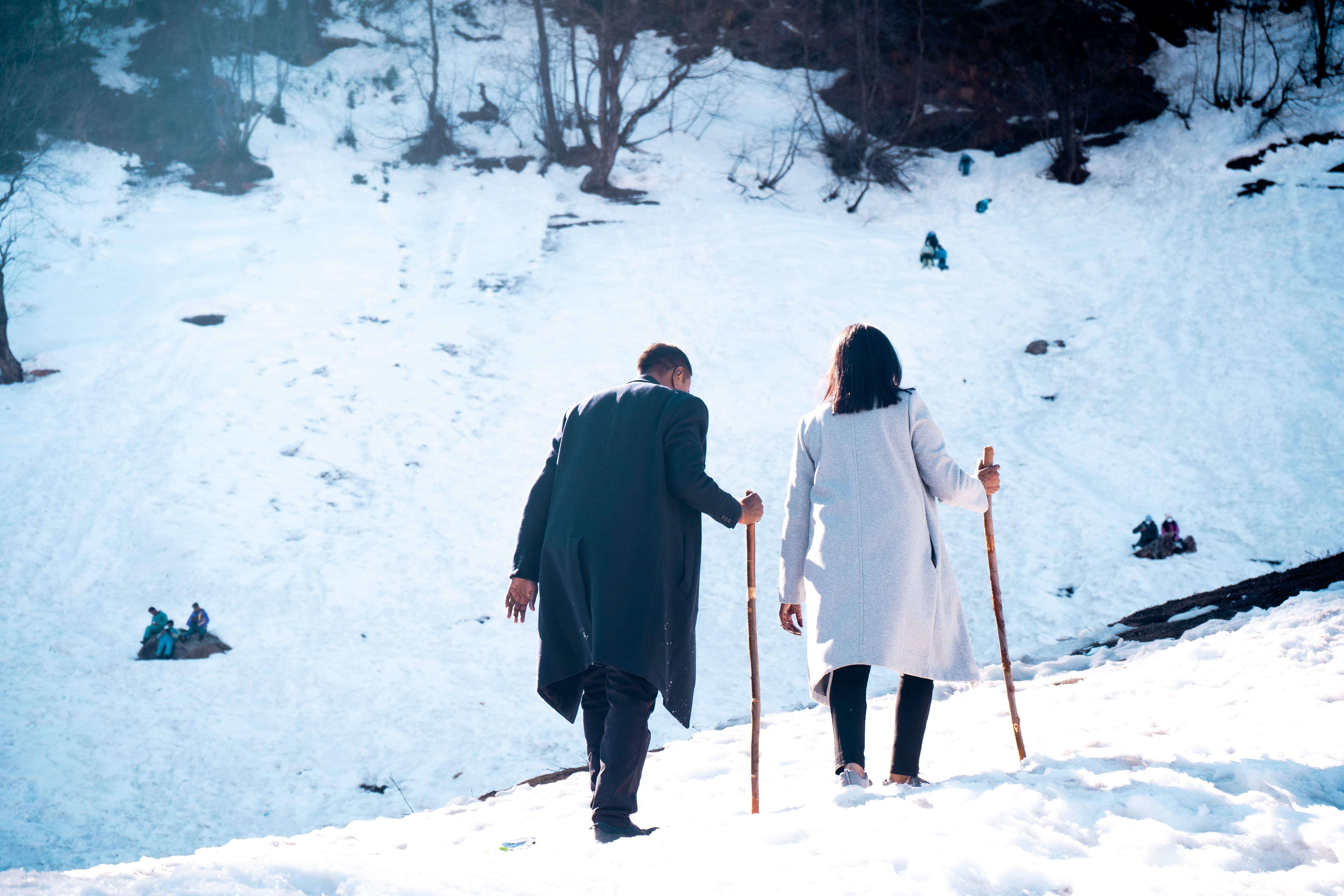 A couple hikes up the snowy hills of Solang Valley