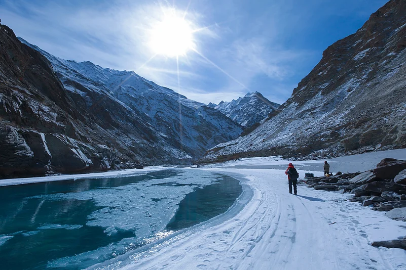 Adventurers cross the frozen Zanskar River on the iconic Chadar Trek in Ladakh